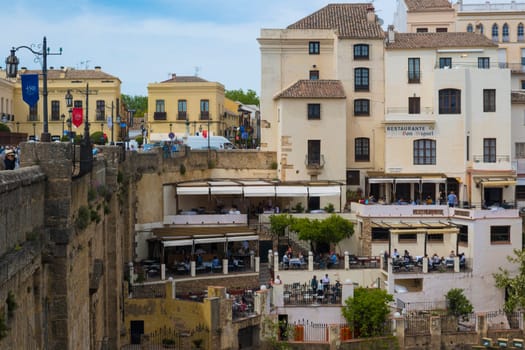 Ronda, Spain, April 2023: View on bars en restaurants next to Puente Nuevo in Ronda, Spain