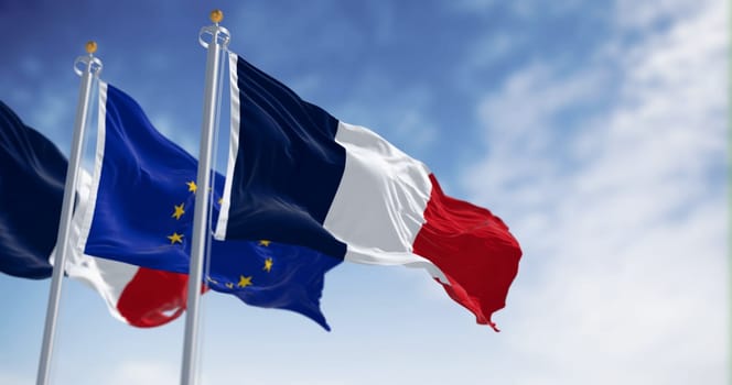 The flags of France and the European Union waving together on a clear day. France became a member of the European Union on January 1, 1958. 3d illustration render. Selective focus. Fluttering fabric