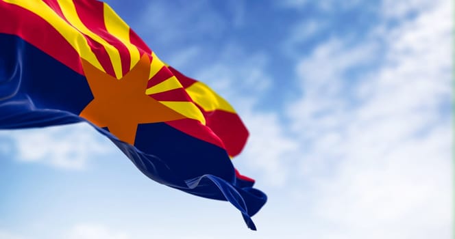 The flag of Arizona waving in the wind on a clear day. Copper star, 13 rays of red and yellow, and a blue bottom half. 3d illustration render. Selective focus. Fluttering textile