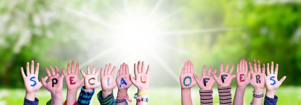 Children Hands Building Colorful English Word Special Offers. Sunny Green Grass Meadow As Background.