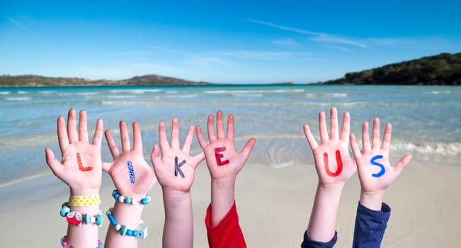 Children Hands Building Colorful English Word Like Us. Summer Ocean, Sea And Beach As Background