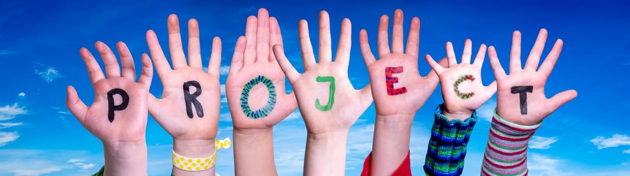 Children Hands Building Colorful English Word Project. Blue Sky As Background