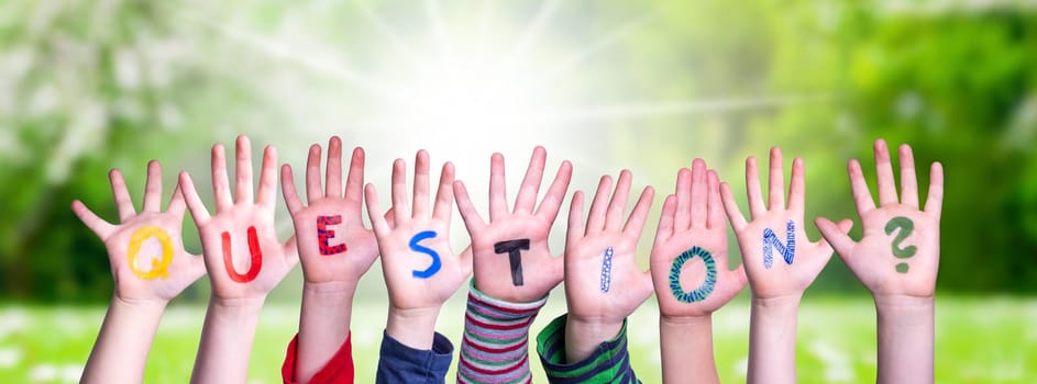 Children Hands Building Colorful English Word Question. Summer, Sunny Green Grass Meadow As Background