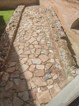 Merida, Spain - April 14th, 2023: Ancient Roman road at Emerita Augusta City. View from National Museum of Roman Art in Merida, Spain