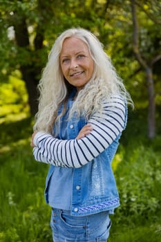 Beautiful elderly woman with her arms crossed in a public Park