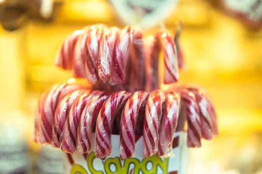 Close-up photo of Christmas and New Year decorations. Decorated with candy stick cane. Stylish outdoor Xmas decorations