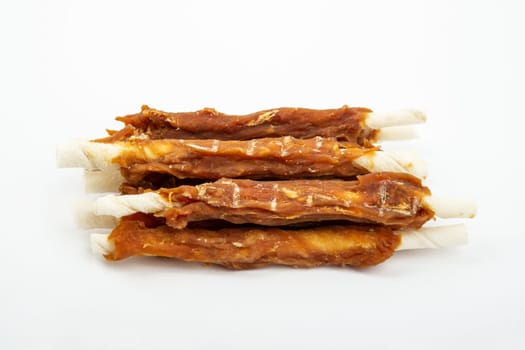 Pile of Buffalo skin with chicken meat for dog over bright background