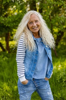 Beautiful Woman with hands in pocket in a puplic park on a sunny day