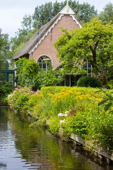 GIETHOORN, NETHERLANDS -typical dutch county side of houses and gardens