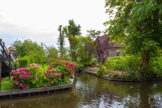 GIETHOORN, NETHERLANDS -typical dutch county side of houses and gardens