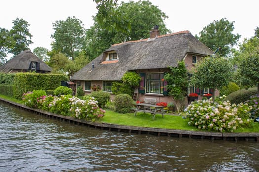GIETHOORN, NETHERLANDS -typical dutch county side of houses and gardens