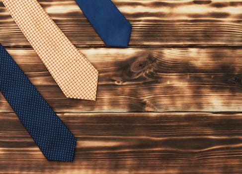 Men's ties on a rustic wooden tabletop. Flat lay. Top view. Copy space