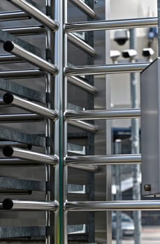 Full-height turnstile guarded stadium entrance. Revolving door