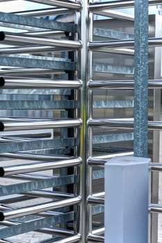 Full-height turnstile guarded stadium entrance. Revolving door