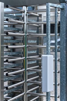 Full-height turnstile guarded stadium entrance. Revolving door