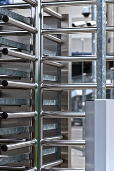 Full-height turnstile guarded stadium entrance. Revolving door