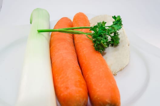 Composition with fresh raw soup vegetables. Herbs,celery with carrots and porree.
