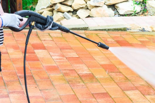Outside floor cleaning and building cleaning with high-pressure water jet.