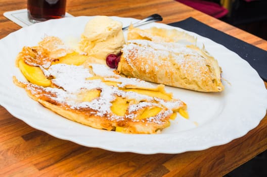Egg pancake with apple on a plate in a restaurant