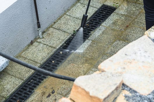 Outside floor cleaning and building cleaning with high-pressure water jet.