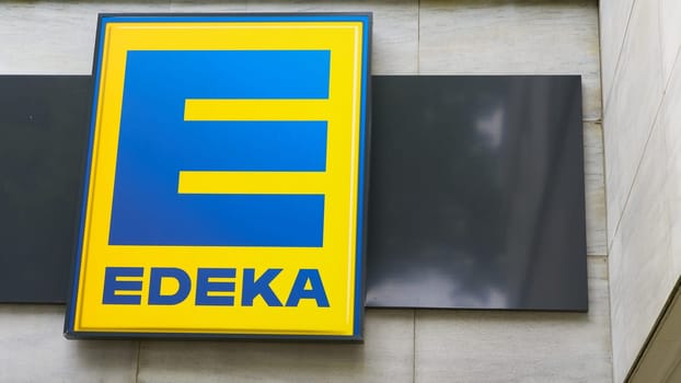 Illuminated sign of the German food discounter Edeka at a branch in Berlin