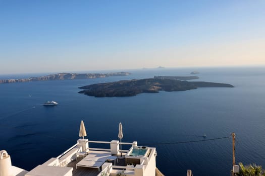 Imerovigli, Santorini, Greece - June 29, 2021: Beautiful white terrace in the village of Imerovigli with amazing view on caldera. Santorini, Greece