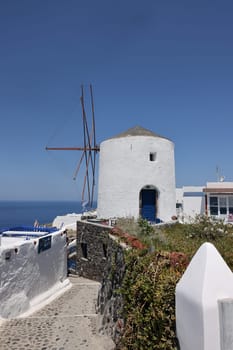 Traditional white windmill in Oia on the island of Santorini. Cyclades, Greece