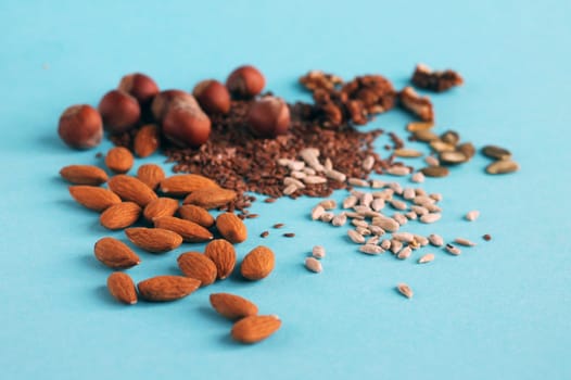 Mixed nuts and seeds blue background.