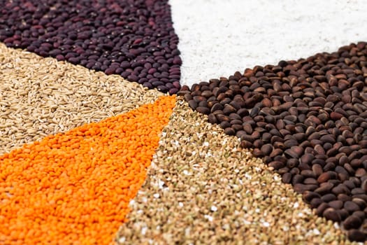 Background of triangles lined with various cereals and nuts on a craft paper