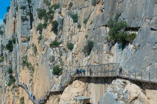 El Chorro, Spain, April 2023: People walking the Caminito Del Rey in the Desfiladero de los Gaitanes, a gorge carved by the Guadalhorce river in the province of Málaga, Spain