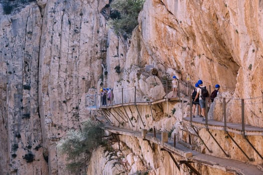 El Chorro, Spain, April 2023: People walking the Caminito Del Rey in the Desfiladero de los Gaitanes, a gorge carved by the Guadalhorce river in the province of Málaga, Spain