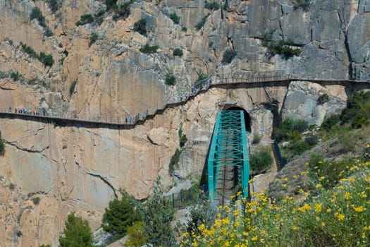 El Chorro, Spain, April 2023: People walking the Caminito Del Rey in the Desfiladero de los Gaitanes, a gorge carved by the Guadalhorce river in the province of Málaga, Spain