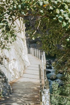 Empty wooden walkway next to the cliffs of the Caminito Del Rey in El Chorro, Spain.