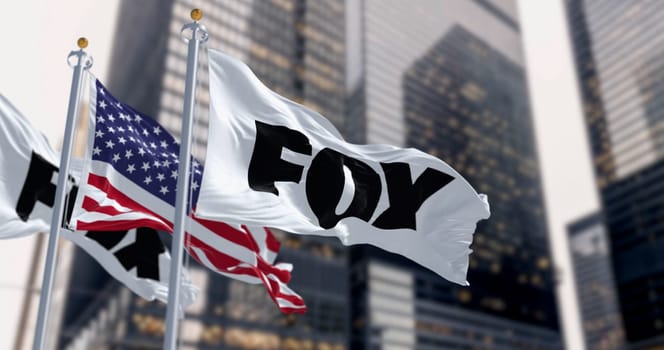New York, US, April 2023: Flags with the Fox logo and the American national flag waving in a financial district. Fox is an American commercial broadcast television network. Illustrative editorial 3D illustration render