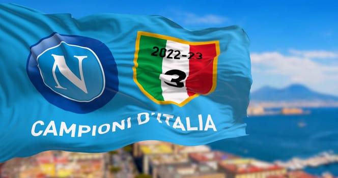 Naples, IT, april 2023: The celebratory flag for Napoli third championship victory waving with the Gulf of Naples blurred in the background. Illustrative editorial 3d illustration render
