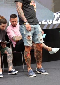 Krakow, Poland - June 11, 2022: Unidentified participant during the contest for the best tattoo at the 15th Tattoofest Convention in Cracow. One of the most prestigious tattoo festivals.