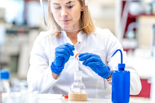research of dangerous chemical substances in the biochemical laboratory of the Scientific Institute. Use protective equipment, glass face mask and rubber gloves.