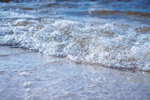 Close-up of pearl sea foam from incoming wave. Relaxation. Interior paintings. Wonderful moments of life. Tourism and travel. Splendor of nature. Rest and pleasure. Enjoying beautiful.
