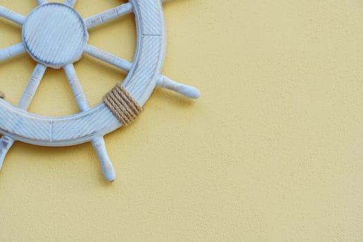 Vacation on yacht. White marine steering wheel on light background. Sea voyages and adventures. Promotional postcards. Excursions and entertainment. Decorative elements in nautical style.