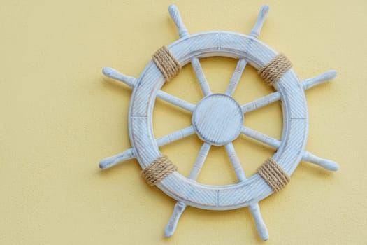 White marine steering wheel on light background. Sea voyages and adventures. Vacation on yacht. Promotional postcards. Excursions and entertainment. Decorative elements in nautical style.