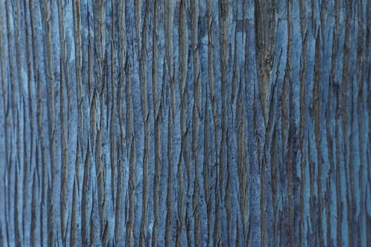 Textured natural indigo coating, with vertical pattern of uneven stripes. Colored background. Modern wallpaper and plaster. Use of natural materials and dyes. Interior design.