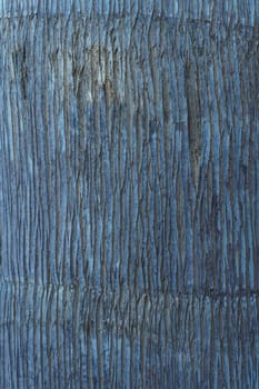 Close-up. Textured natural indigo coating, with vertical pattern of uneven stripes. Colored background. Modern wallpaper and plaster. Use of natural materials and dyes. Interior design.