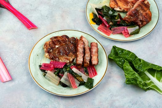 Delicious grilled meat steak and fresh herb salad. Top view.