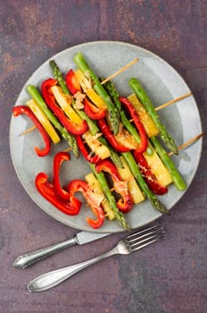 Diet skewers of asparagus, peppers and cheese. Grilled skewers vegetables. Copy space.