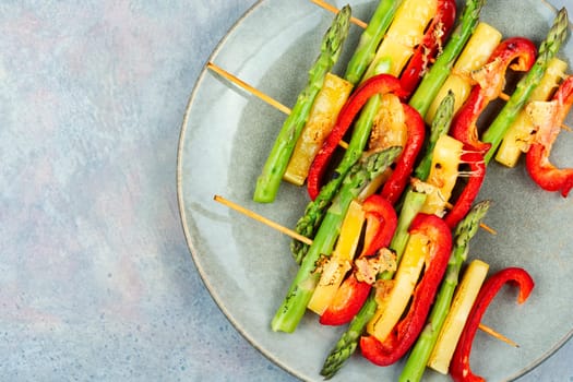 Diet skewers of asparagus, peppers and cheese. Grilled skewers vegetables. Copy space.