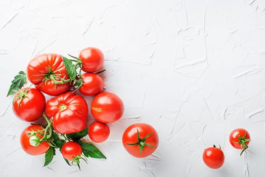 Fresh tomatoes on white table background. Harvesting tomatoes. Cooking healthy meal.