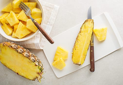 Fresh sliced pineapple on white bright table background, top view closeup
