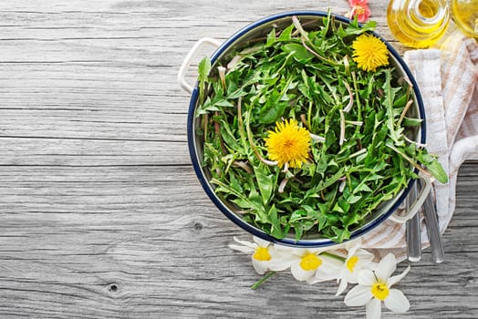 Fresh dandelion salad with dressing. Healthy spring food concept