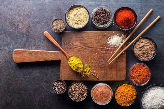 Colorful ingredients, herbs and spices for cooking dishes. Asian spices for Chinese cuisine concept On dark background. Top view.