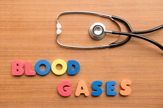 Blood gases colorful word with stethoscope on the wooden background